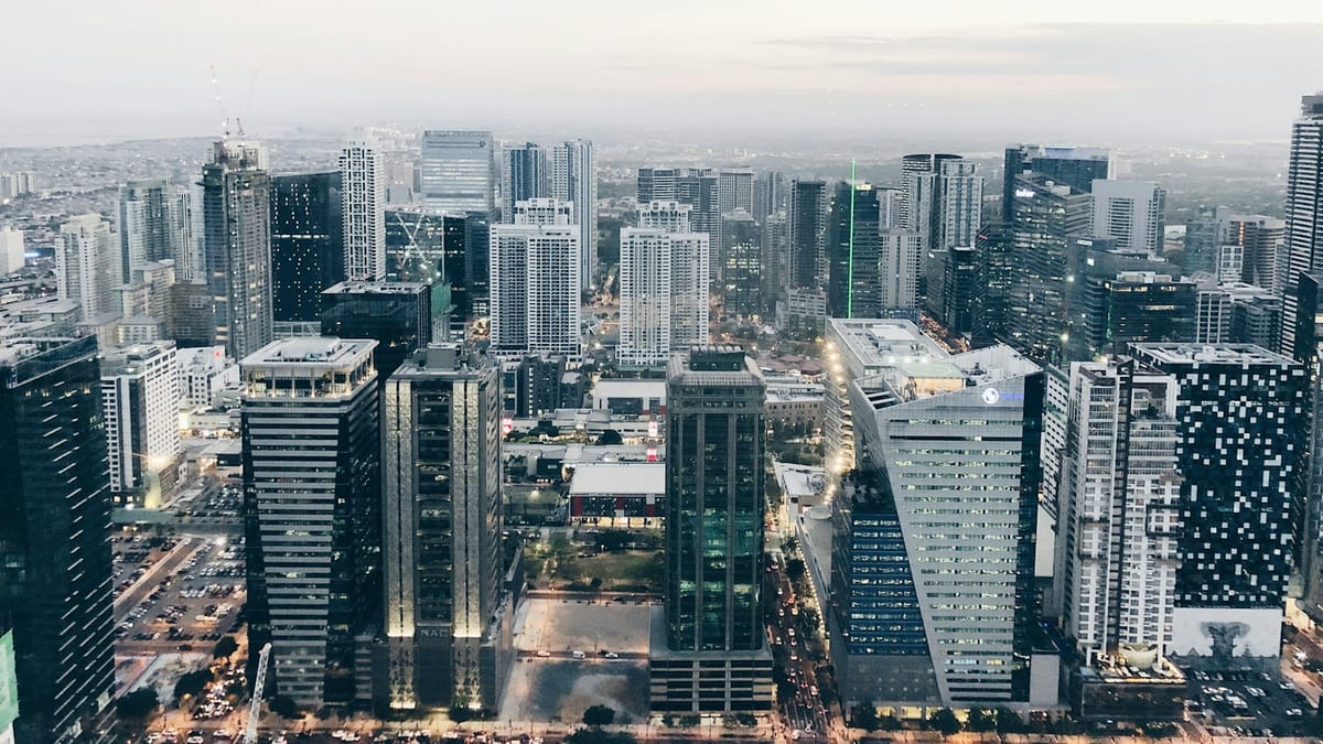 Aerial view of a dense city skyline with high-rise buildings at dusk