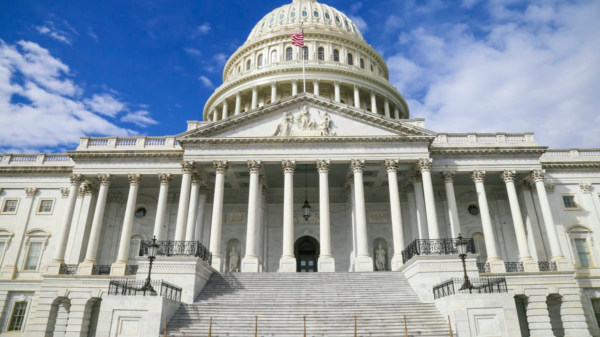 The United States Capitol building with its white dome against a blue sky